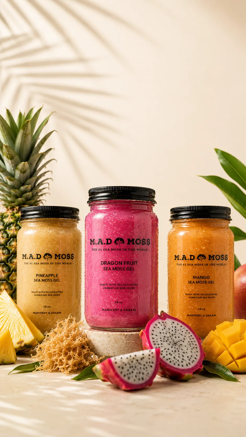 A lineup of branded M.A.D MOSS sea moss gel jars in colorful flavors with fresh fruit