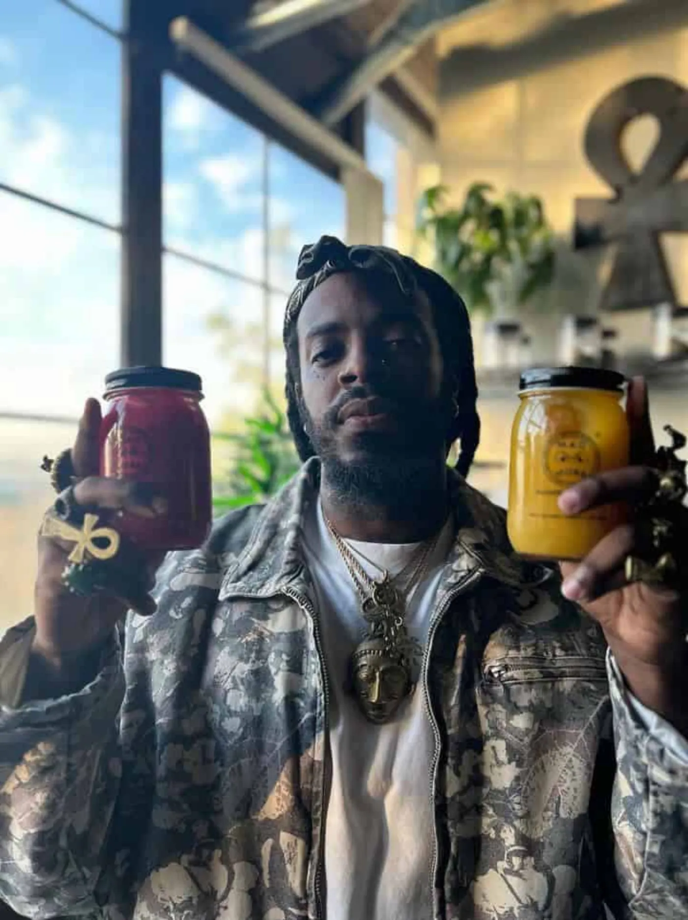 M.A.D MOSS founder holding two sea moss gel jars