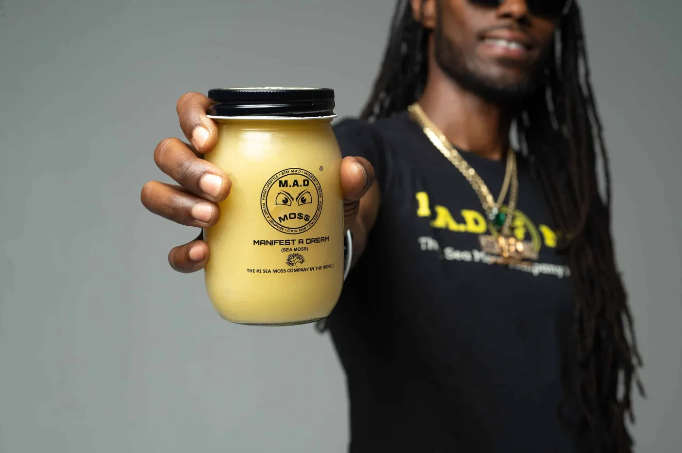 The founder of M.A.D MOSS holding a jar of Original sea moss gel